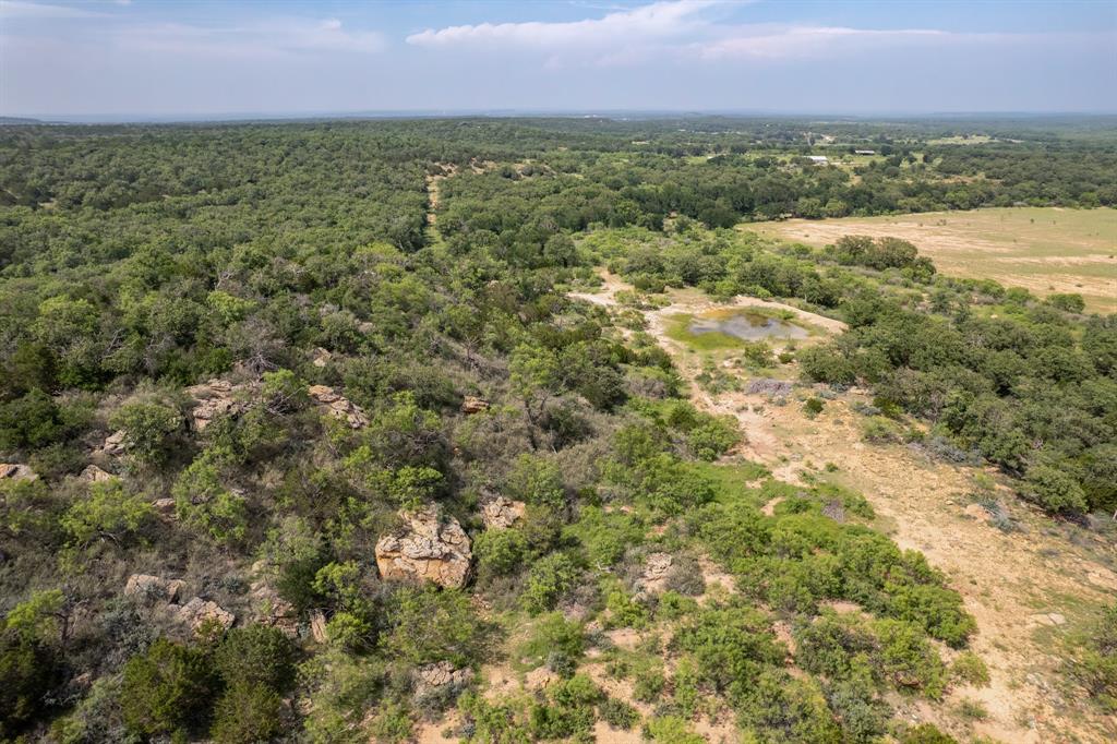 4451 Farm To Market 585 Bangs, TX 76823 - Photo 21 of 40 an aerial view of residential houses with outdoor space and trees
