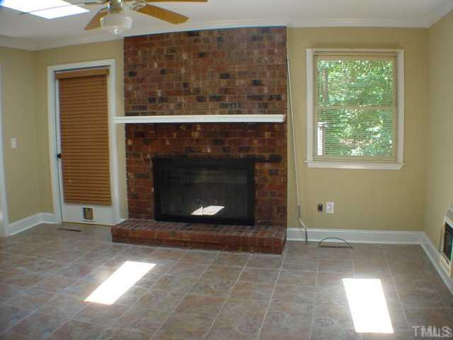 4404 Malvern Road Durham, NC 27707 - Photo 6 of 12 Den/Family/Great Room: Woodburning fireplace or suitable for gas logs. Tile floors and showing exit on to one of the two screened porch. This porch opens to the privacy deck and the back yard area. Den/Family/Great Room