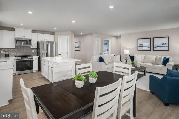 a living room with kitchen island furniture and a kitchen view