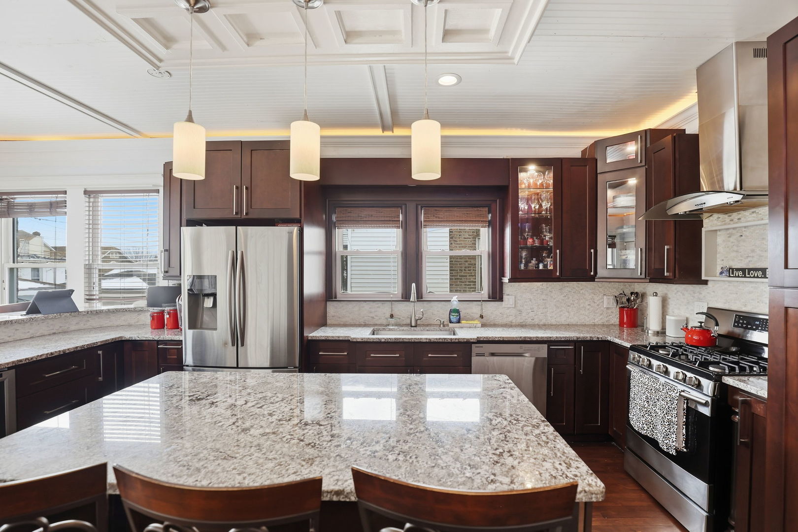 2407 Highland Avenue Berwyn, IL 60402 - Photo 11 of 25 a large kitchen with cabinets chairs and stainless steel appliances
