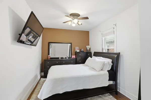 a bedroom with a bed and a painting on the wall