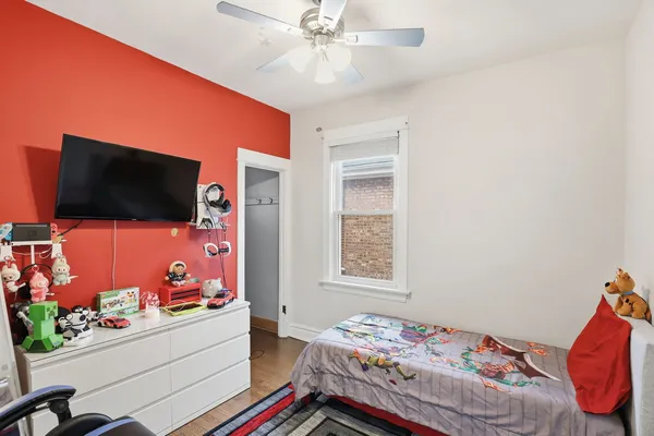 a bedroom with a bed and flat screen tv