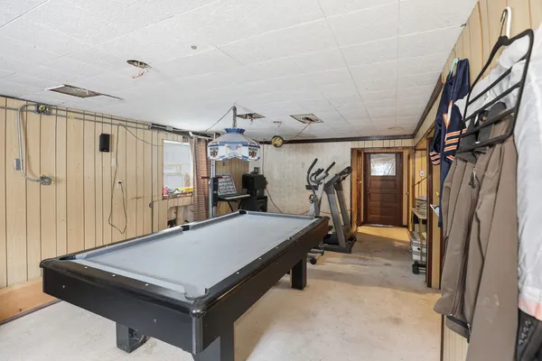 a room with pool table and glass door