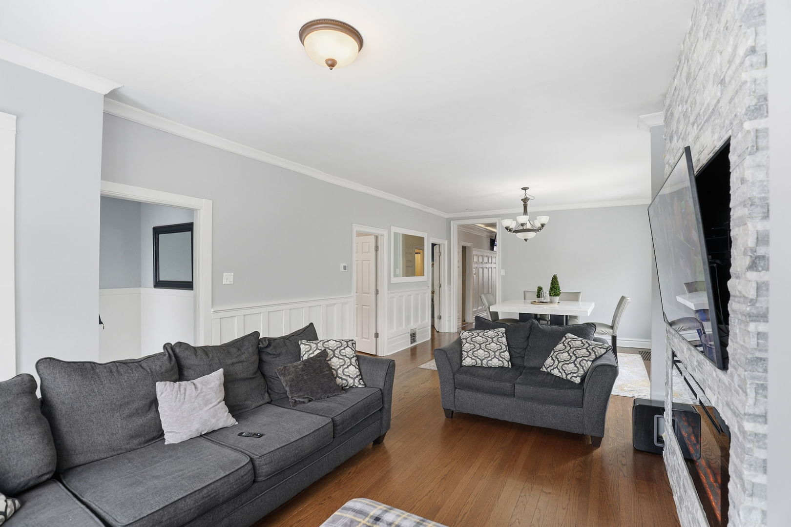 2407 Highland Avenue Berwyn, IL 60402 - Photo 7 of 25 a living room with furniture and a flat screen tv