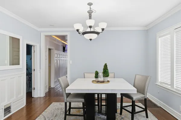 a view of a dining room with a table and chairs