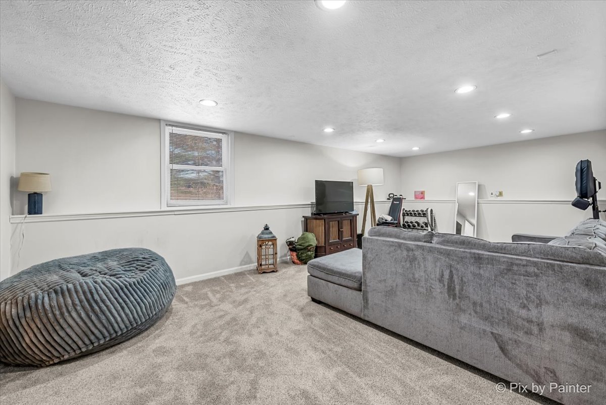 117 Benedict Drive Southwest Poplar Grove, IL 61065 - Photo 14 of 27 a living room with furniture and a flat screen tv