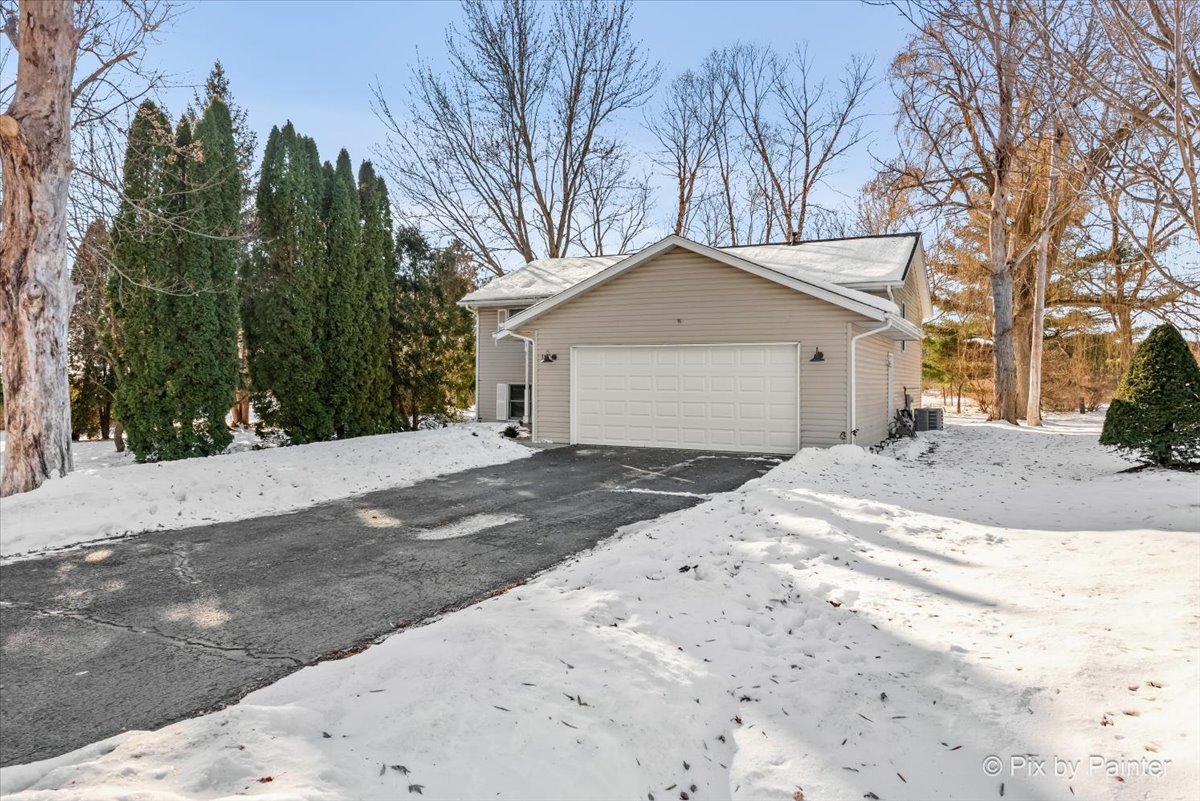 117 Benedict Drive Southwest Poplar Grove, IL 61065 - Photo 20 of 27 a view of a house with a yard covered in snow