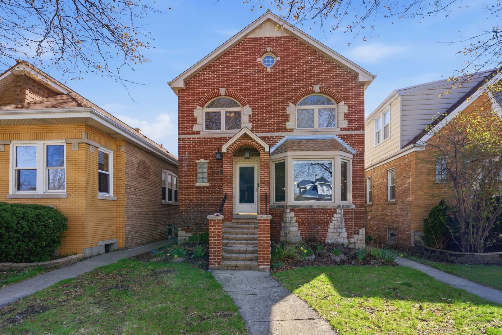 5325 North Meade Avenue Chicago, IL 60630 - Photo 1 of 24 a front view of a house with a garden