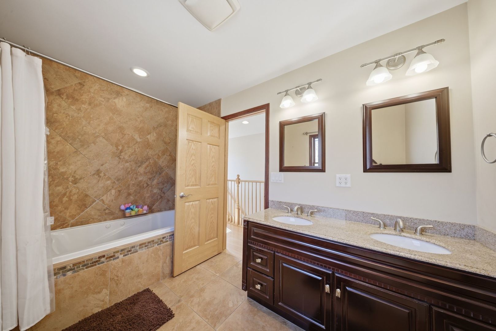 5325 North Meade Avenue Chicago, IL 60630 - Photo 11 of 24 a bathroom with a sink double vanity and a mirror