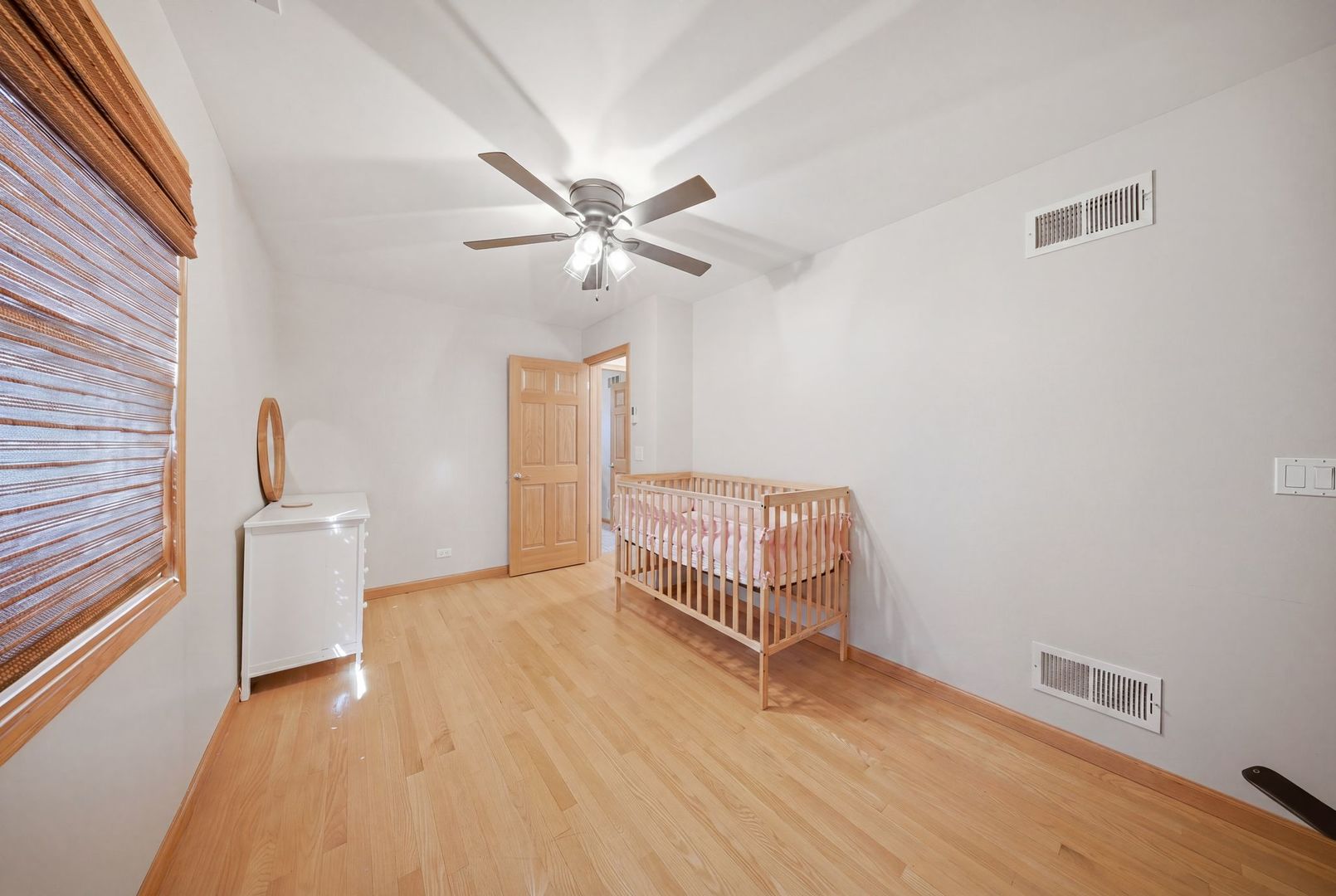 5325 North Meade Avenue Chicago, IL 60630 - Photo 13 of 24 a view of an empty room with a window and wooden floor