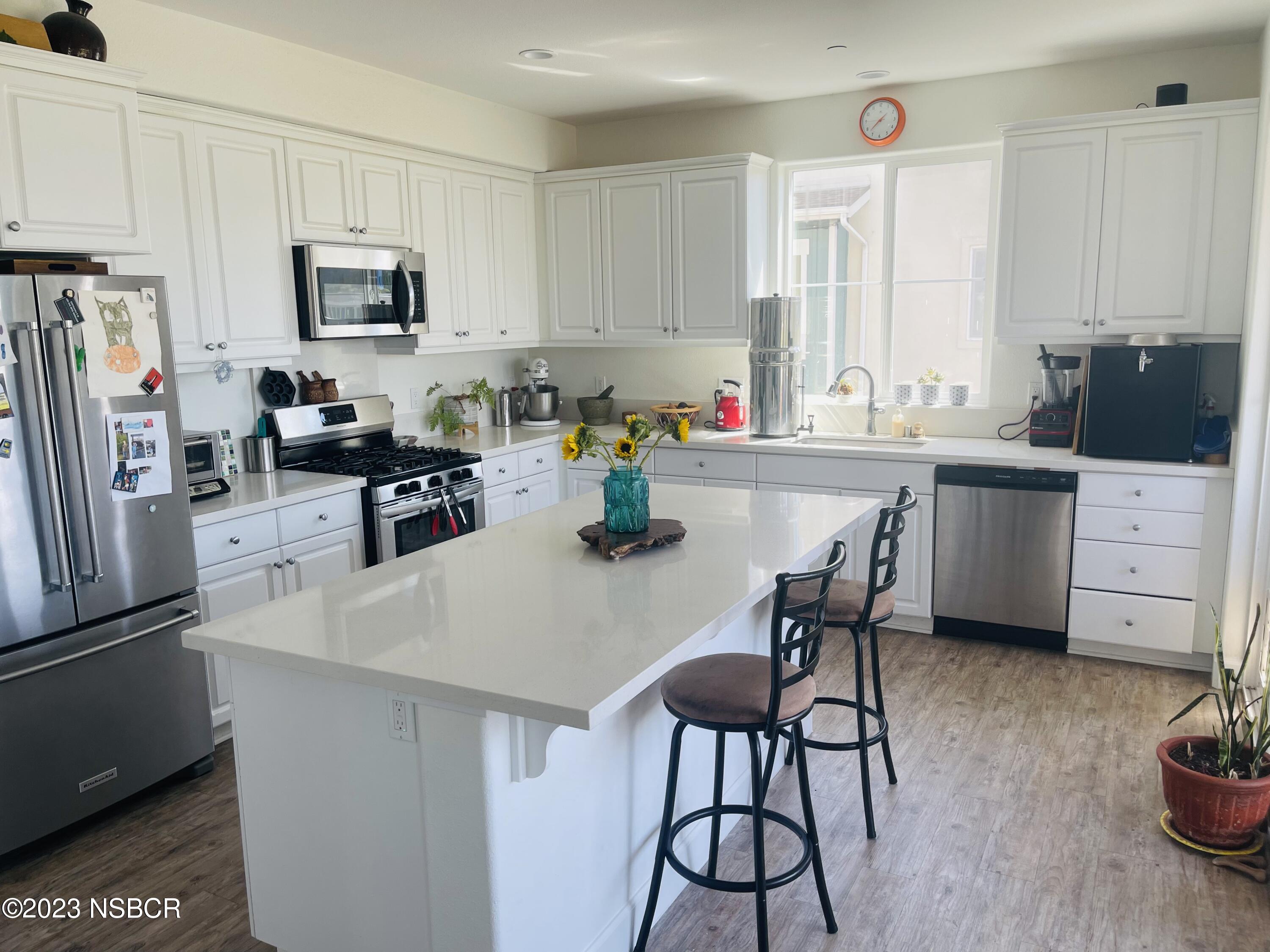 232 Robles Way Buellton, CA 93427 - Photo 2 of 6 a kitchen with a sink a microwave and cabinets