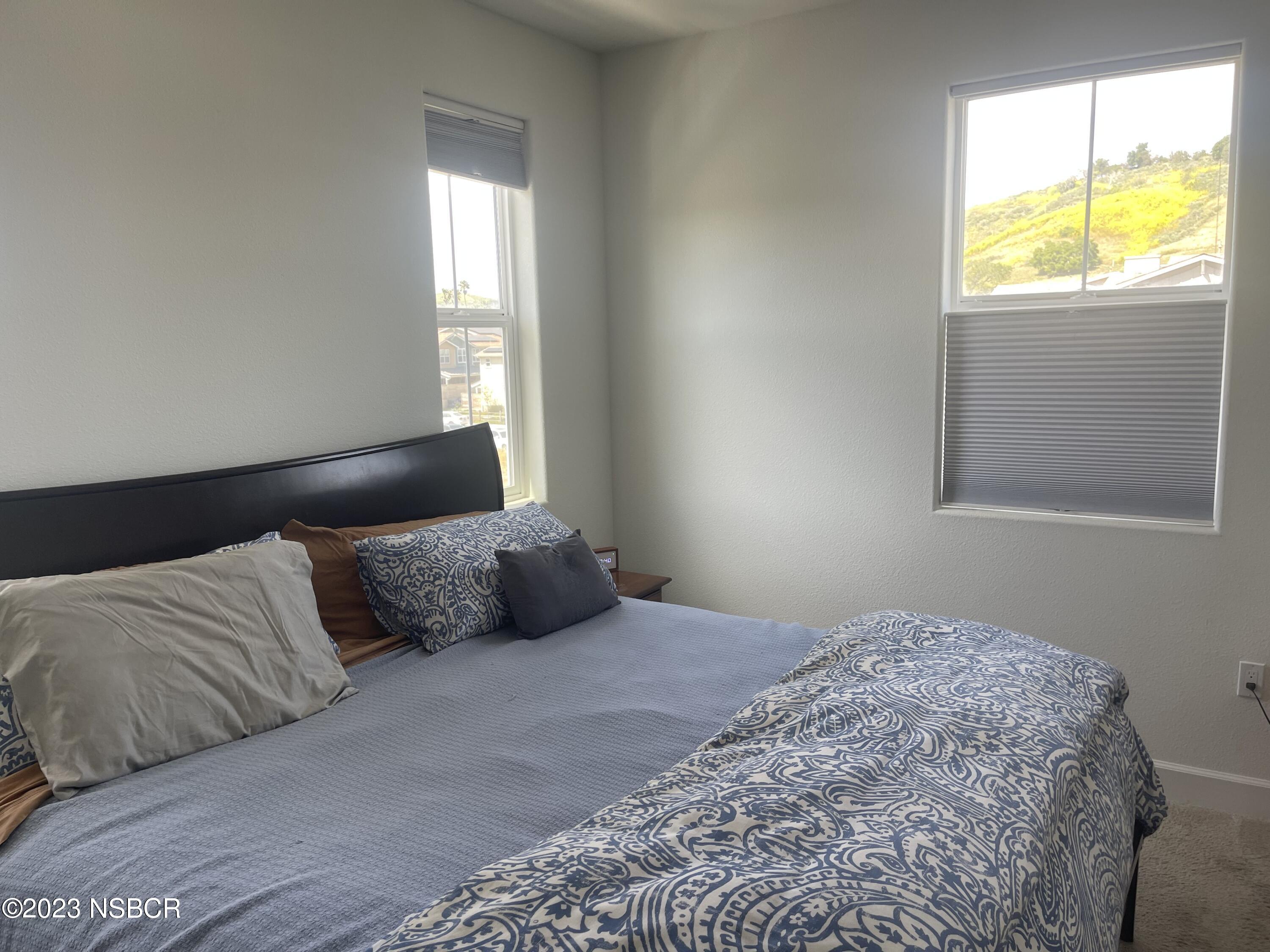 232 Robles Way Buellton, CA 93427 - Photo 5 of 6 a bedroom with a bed and a window