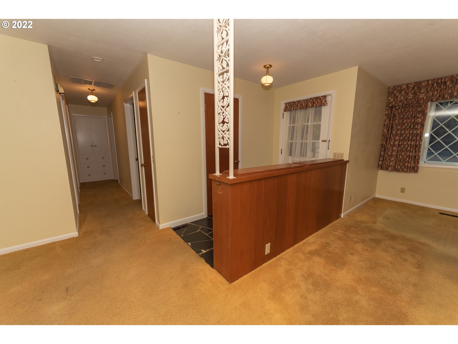 565 East 39th Place Eugene, OR 97405 - Photo 4 of 19 a view of a kitchen with furniture and a refrigerator