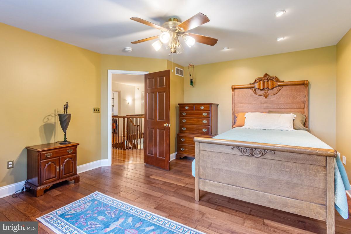 31 Quail Court Littlestown, PA 17340 - Photo 18 of 26 a bedroom with a bed and wooden floor