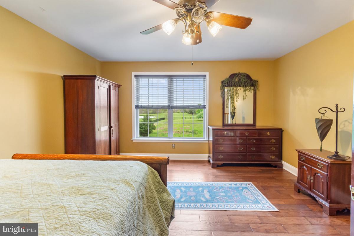 31 Quail Court Littlestown, PA 17340 - Photo 19 of 26 a bedroom with a bed and wooden floor