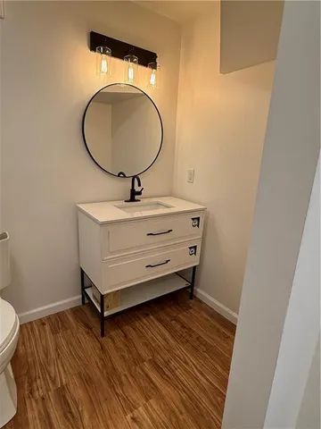 a room with a mirror and a wooden floor