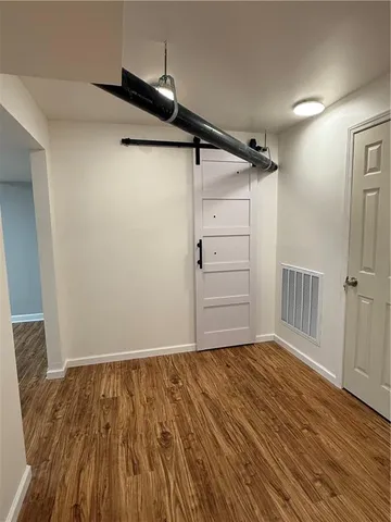 a view of a room with wooden floor