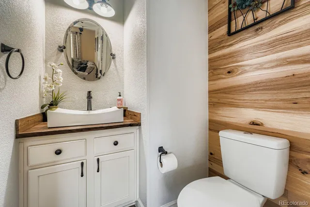 a bathroom with a toilet a sink and mirror