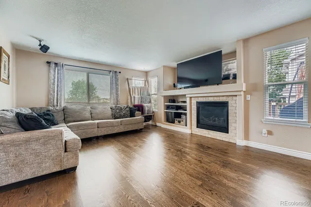 a living room with furniture flat screen tv and a fireplace