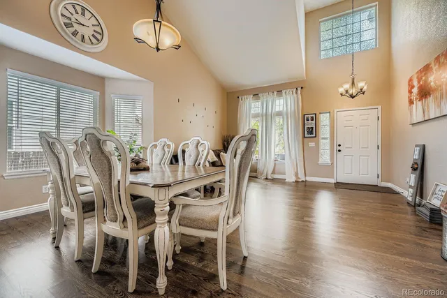 a view of a dining room with furniture wooden floor and chandelier