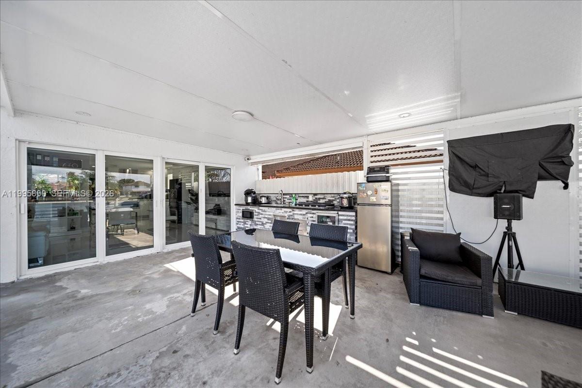 15341 Southwest 36th Street Miami, FL 33185 - Photo 14 of 56 a dining room with furniture and floor to ceiling window