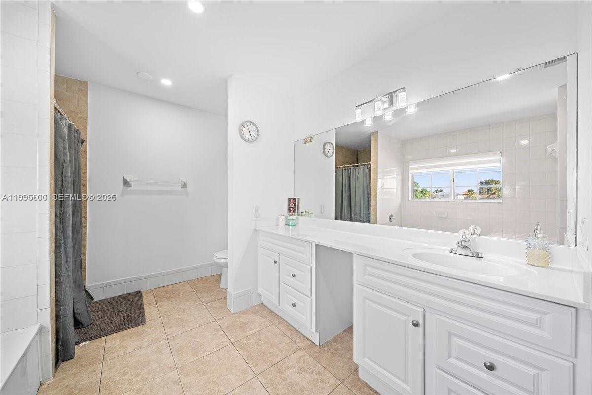 15341 Southwest 36th Street Miami, FL 33185 - Photo 19 of 56 a spacious bathroom with a double vanity sink mirror and double