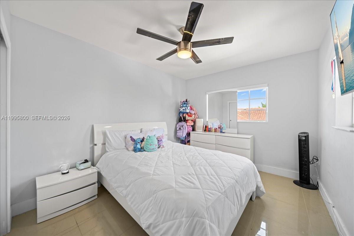 15341 Southwest 36th Street Miami, FL 33185 - Photo 22 of 56 a bedroom with a bed and a chandelier