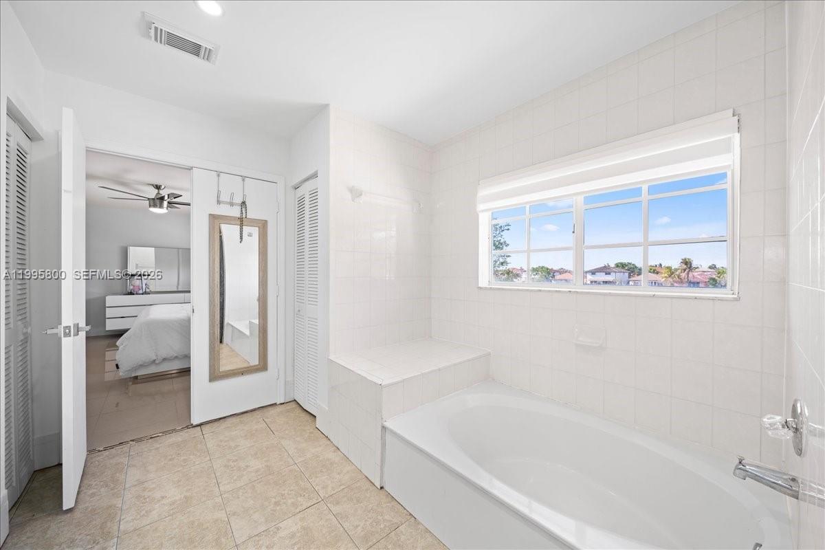 15341 Southwest 36th Street Miami, FL 33185 - Photo 24 of 56 a bathroom with a bathtub and a shower