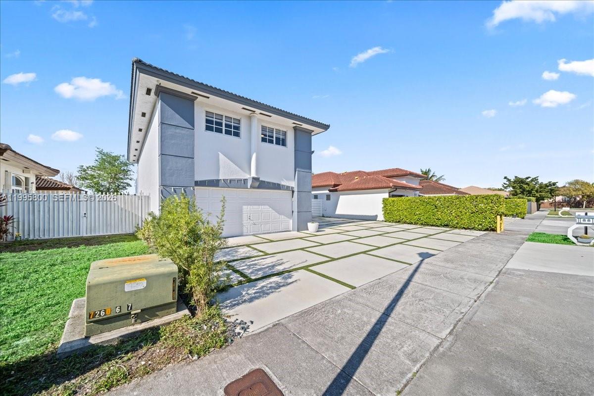 15341 Southwest 36th Street Miami, FL 33185 - Photo 3 of 56 a front view of a house with a yard and outdoor seating
