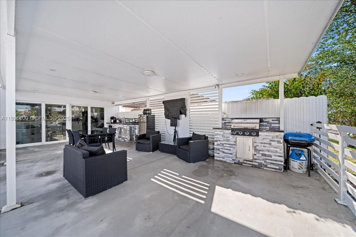 15341 Southwest 36th Street Miami, FL 33185 - Photo 31 of 56 a living room with furniture and a flat screen tv