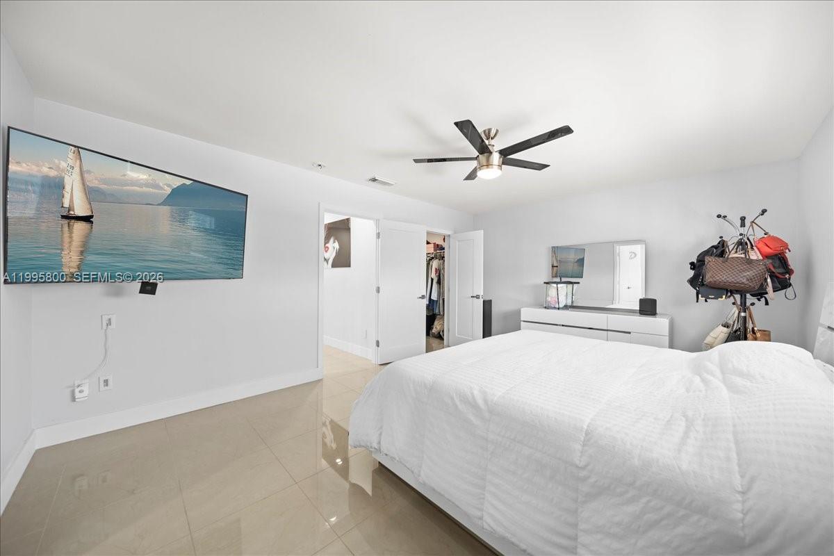 15341 Southwest 36th Street Miami, FL 33185 - Photo 35 of 56 a bedroom with a large bed and a flat screen tv