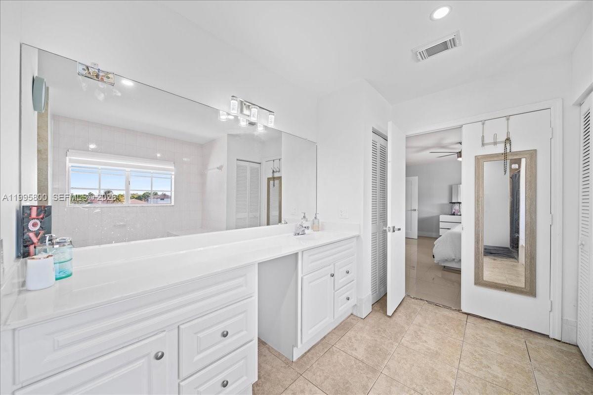 15341 Southwest 36th Street Miami, FL 33185 - Photo 39 of 56 a spacious bathroom with a shower sink and mirror