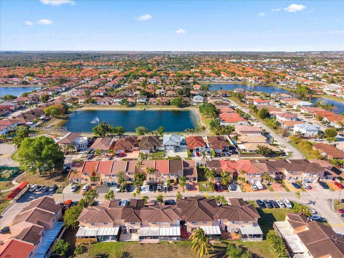 15341 Southwest 36th Street Miami, FL 33185 - Photo 46 of 56 an aerial view of a city with lots of residential buildings ocean and mountain view in back
