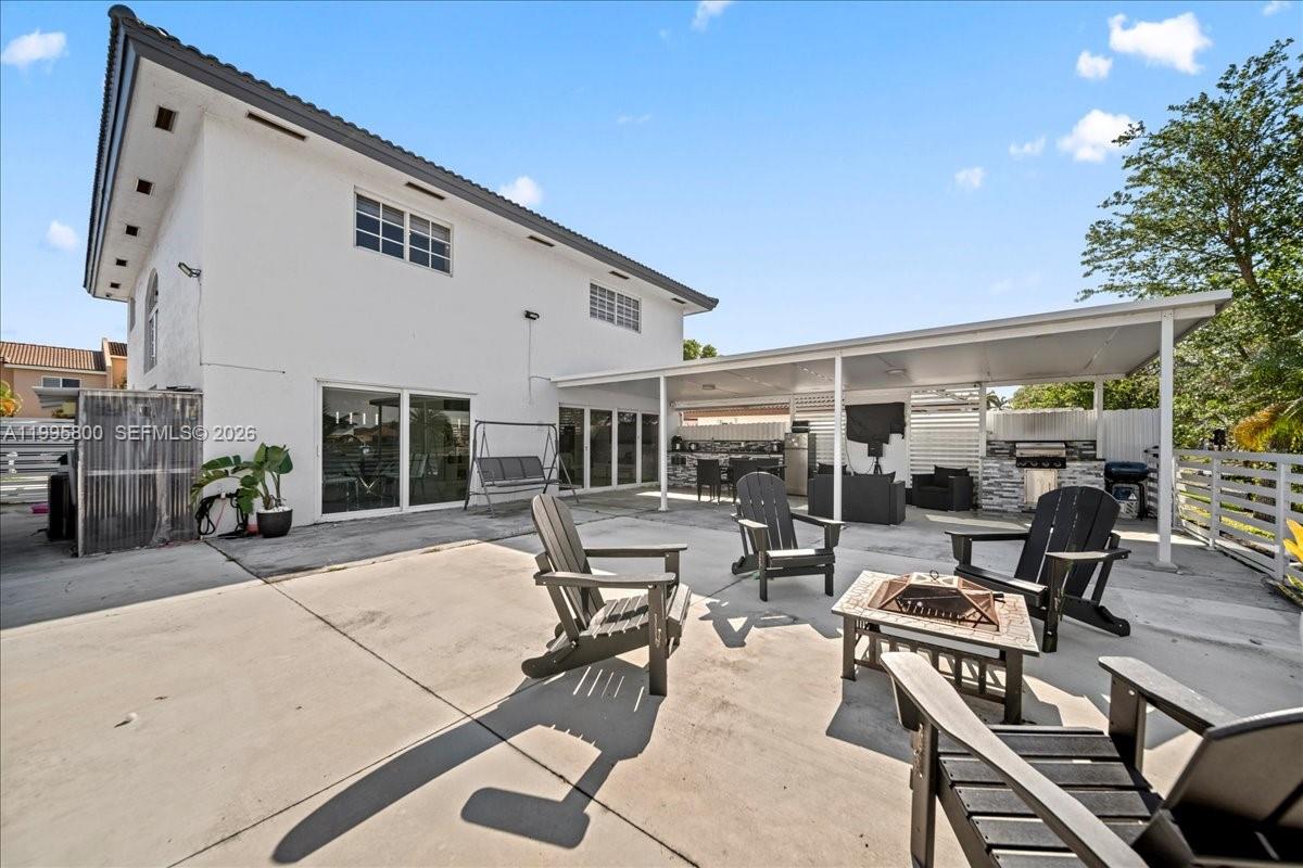15341 Southwest 36th Street Miami, FL 33185 - Photo 6 of 56 a building outdoor space with patio furniture and potted plants