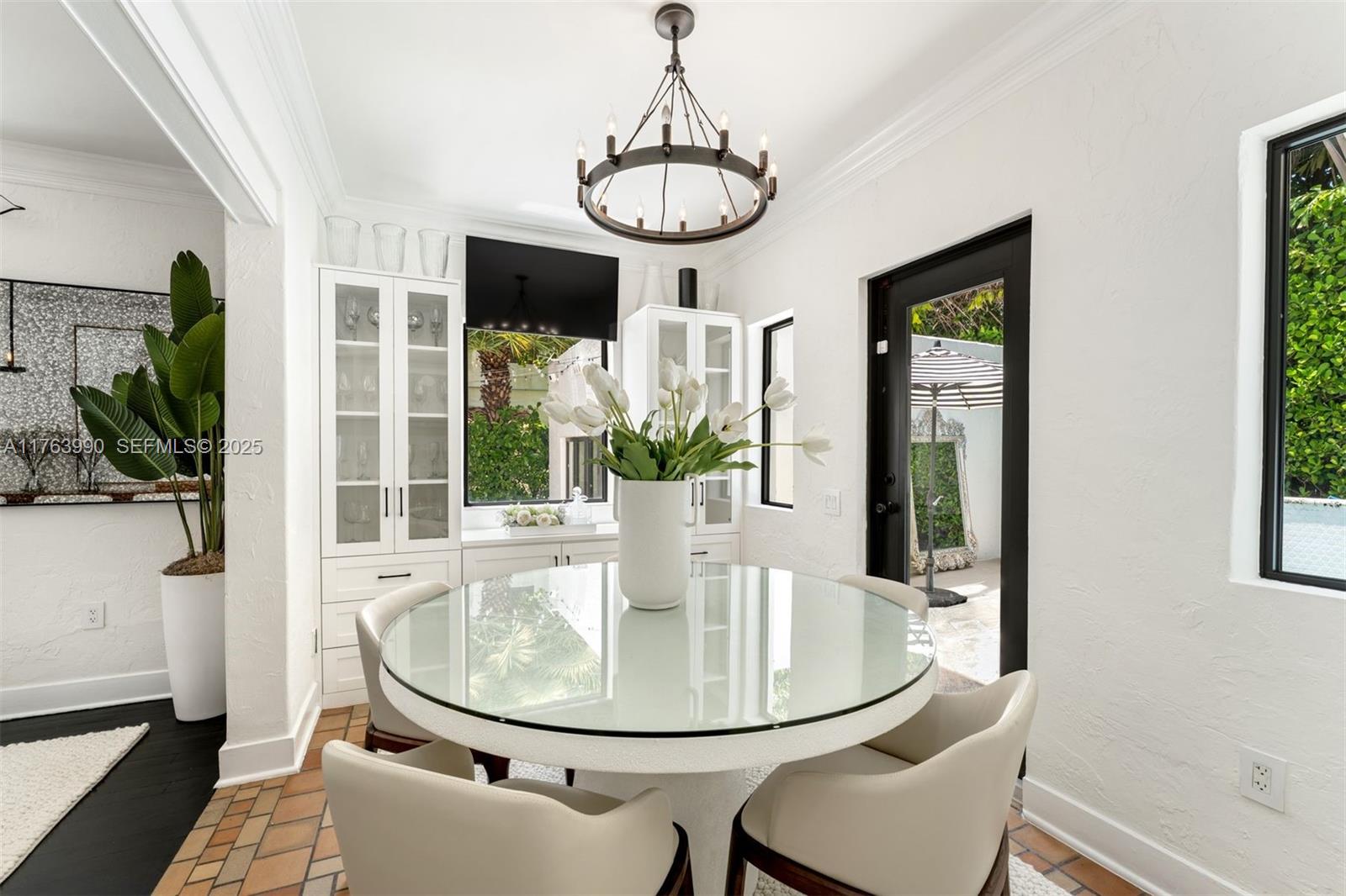 4430 Alton Road Miami Beach, FL 33140 - Photo 13 of 47 a view of a dining room with furniture window and wooden floor