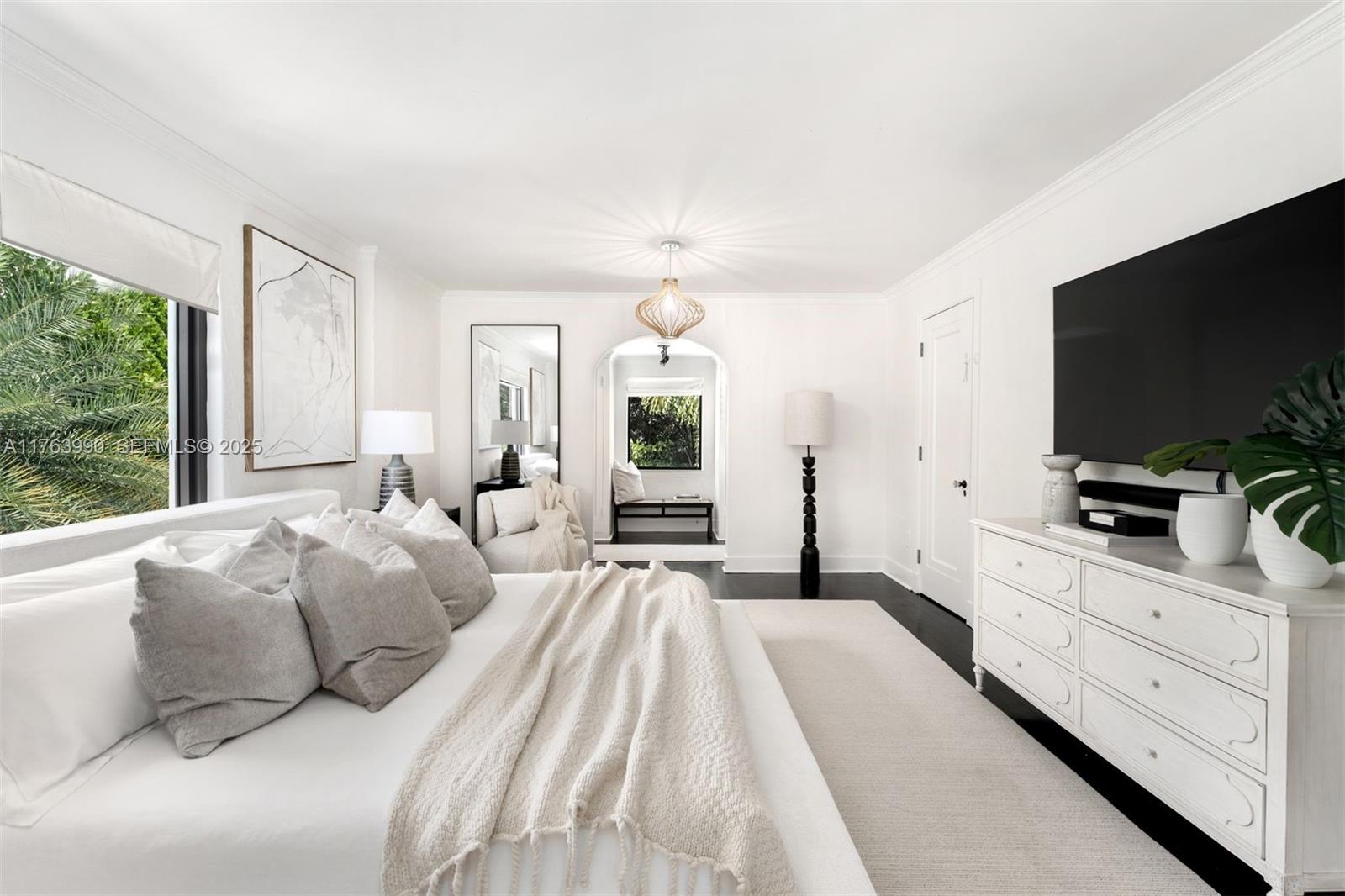 4430 Alton Road Miami Beach, FL 33140 - Photo 16 of 47 a spacious bedroom with a large bed and a flat screen tv