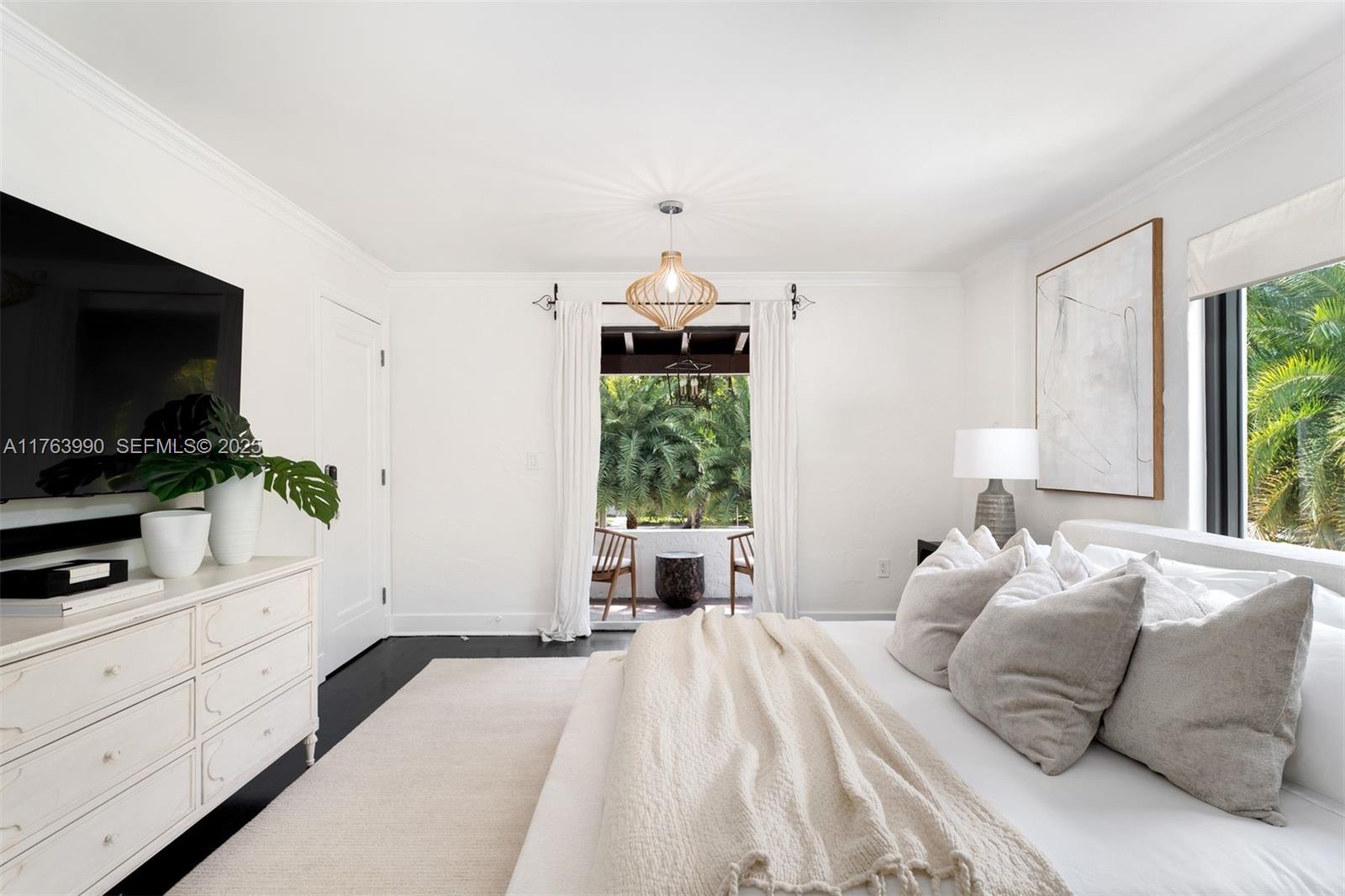 4430 Alton Road Miami Beach, FL 33140 - Photo 17 of 47 a bedroom with a large bed and a flat tv screen on dresser