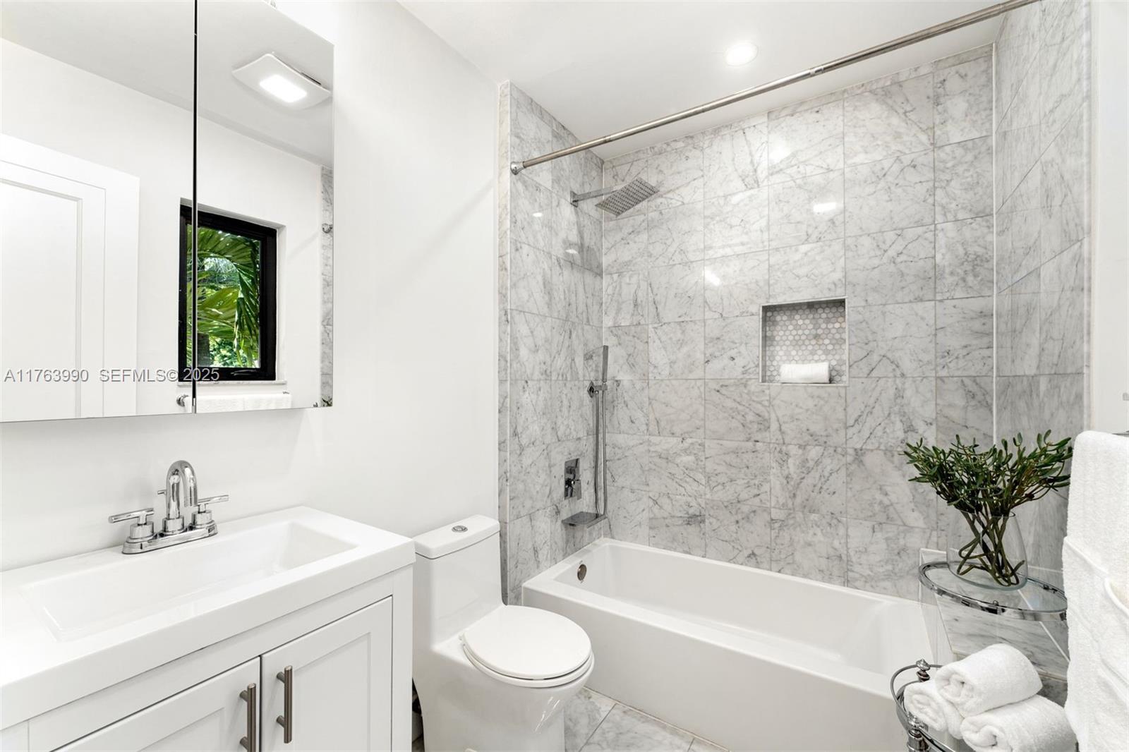 4430 Alton Road Miami Beach, FL 33140 - Photo 23 of 47 a bathroom with a bathtub shower sink and toilet
