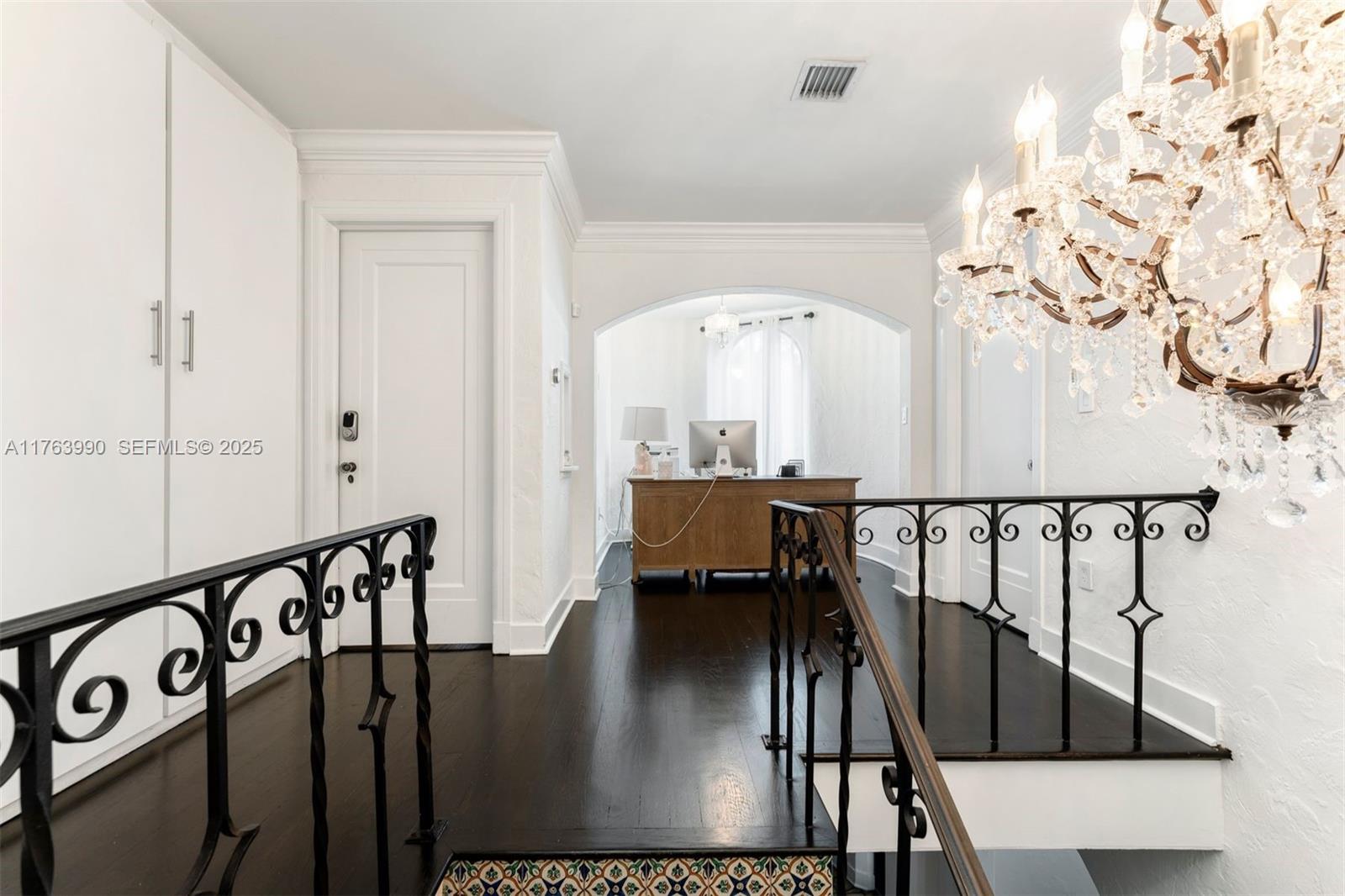 4430 Alton Road Miami Beach, FL 33140 - Photo 27 of 47 a view of entryway and hall with wooden floor