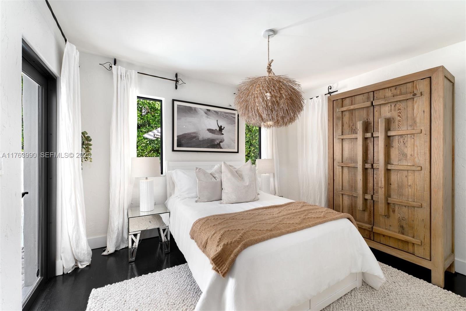 4430 Alton Road Miami Beach, FL 33140 - Photo 29 of 47 a bedroom with a large bed and a chandelier