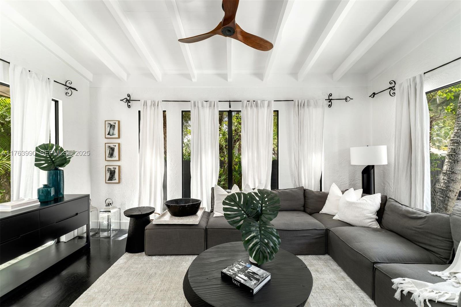 4430 Alton Road Miami Beach, FL 33140 - Photo 6 of 47 a living room with furniture fireplace and a large window