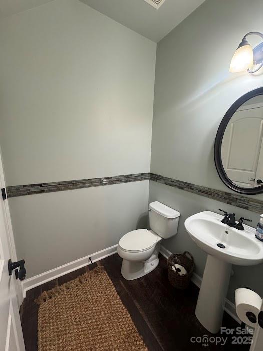 2279 Eversham Drive Northwest Concord, NC 28027 - Photo 17 of 28 a bathroom with a toilet a sink and a mirror