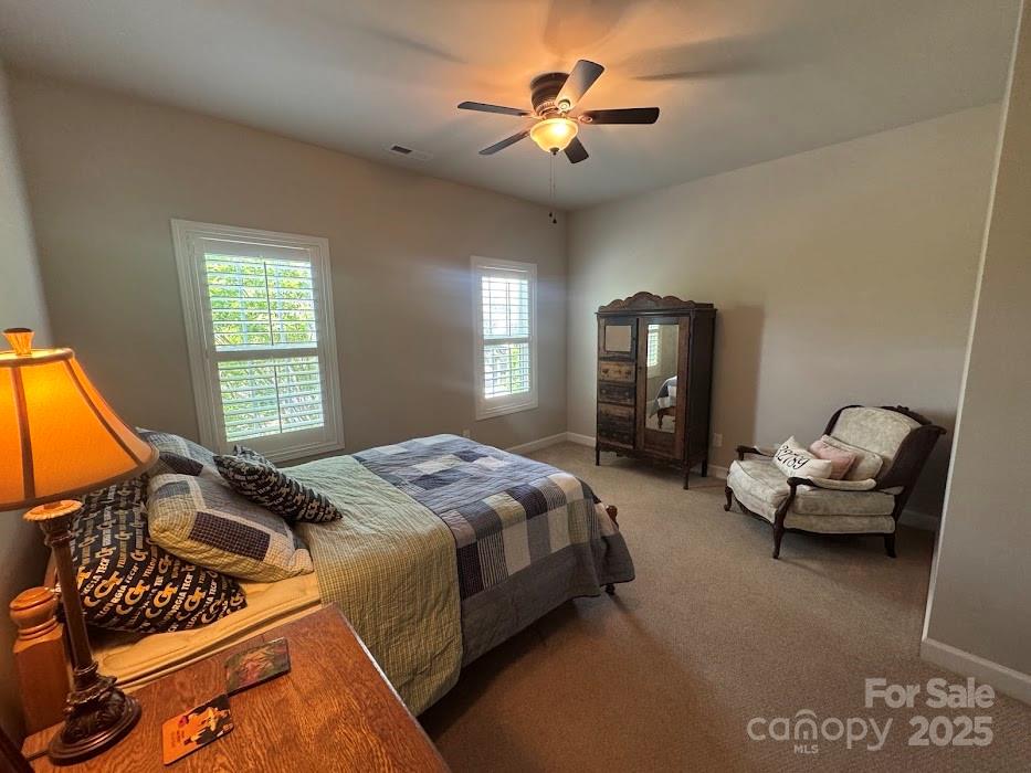 2279 Eversham Drive Northwest Concord, NC 28027 - Photo 21 of 28 a bedroom with a bed and a chandelier