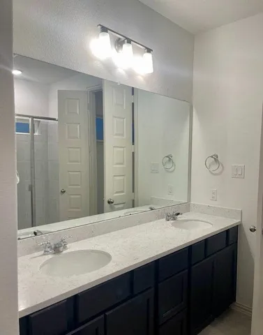 a bathroom with a sink double vanity and a mirror