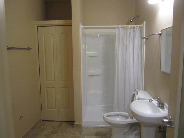 11 North Genesee Street, Unit 200 Waukegan, IL 60085 - Photo 8 of 8 a bathroom with a sink toilet and shower