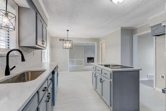 a kitchen with stainless steel appliances granite countertop a white stove top oven and sink