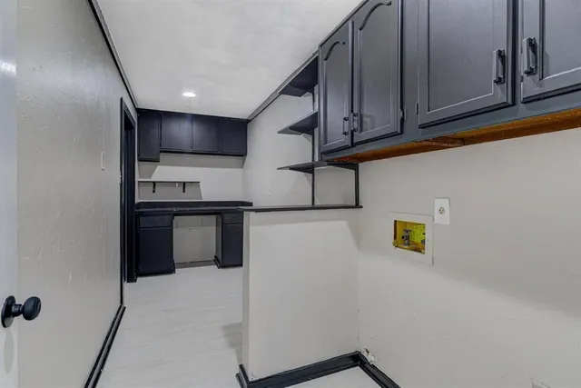 a view of kitchen with cabinets and wooden floor