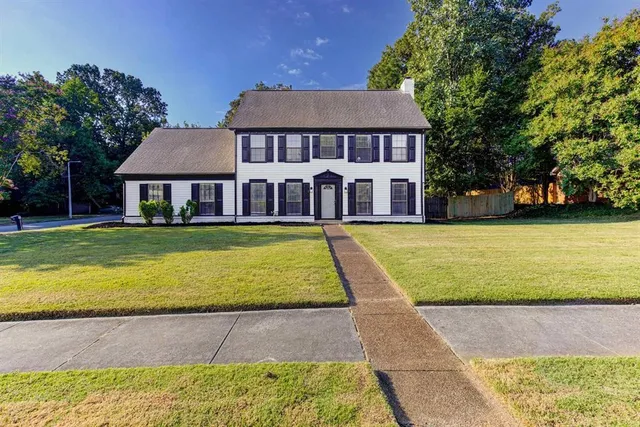 a view of a house with swimming pool and a yard