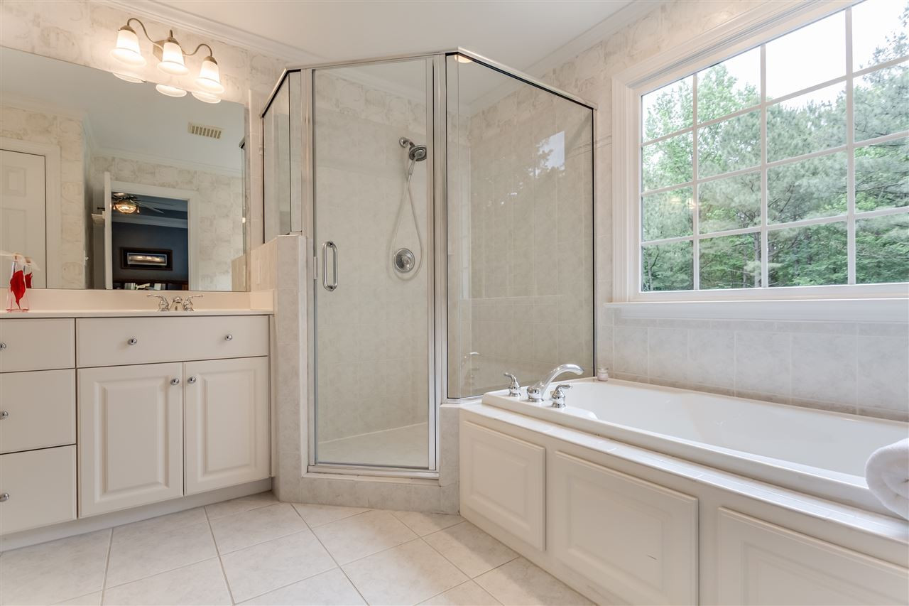 9428 Macon Road Raleigh, NC 27613 - Photo 20 of 25 New shower enclosure, tile floors, and new fixtures. Features huge walk in closet! Master Bath/Spa