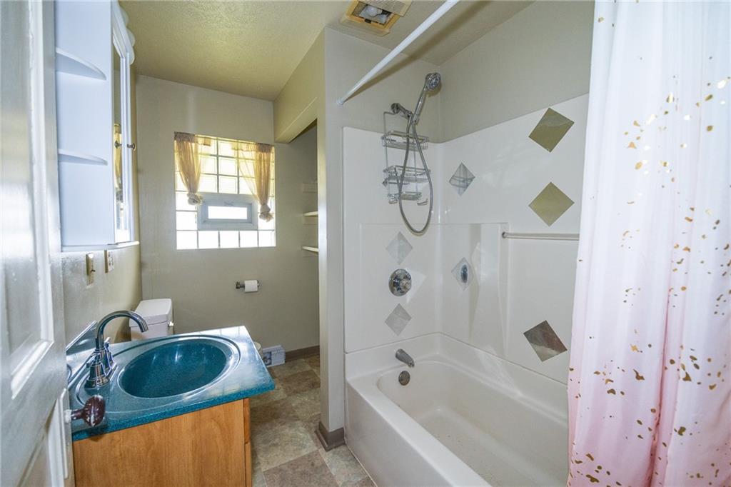511 2nd Street Monessen, PA 15062 - Photo 12 of 21 a bathroom with a tub sink and shower